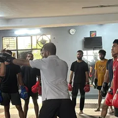 I am demonstrating the correct way to throw a punch to a student. Close supervision and correction are key to developing proper technique.