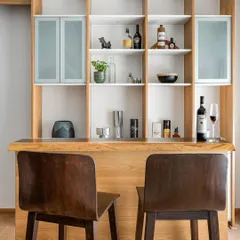 A full-height bar and display unit from our 'Pepper and Coffee' project. The design features a live-edge wood counter, open shelving for display, and closed cabinets with fluted glass.