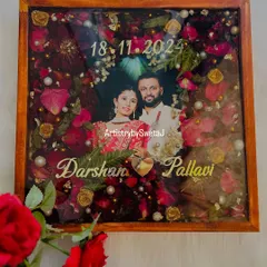 A full view of this heartfelt wedding keepsake. The deep red of the preserved roses contrasts beautifully with the wooden frame, creating a rich and timeless piece of art for the couple's home.