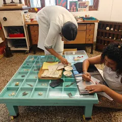 A guide assists a parent during our community sewing project. We learn from each other, sharing skills and stories as we create something beautiful and meaningful for our children.