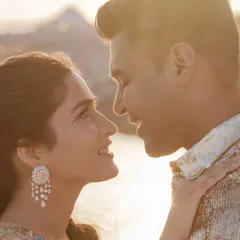 A sun-kissed, close-up portrait of the couple on the deck, their love shining as brightly as the ocean.