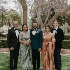 A portrait of the groom with his immediate family. This image highlights the color harmony we created, with the groom's teal jacket standing out against his mother's sage green, his sister's rusty rose gold, and his father's and brother-in-law's classic black tuxedos.