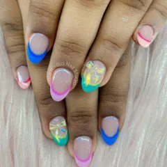 A rainbow of colors on your nails. This modern French manicure features tips in blue, pink, and teal, with accent nails showcasing a beautiful translucent bow design.