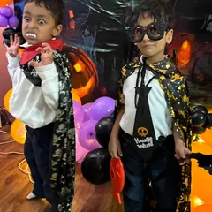 Don't mess with us! Two boys in their Halloween best, one as a vampire and the other ready for a spooky party.