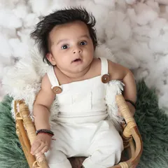 A sweet three-month-old boy looking up with an inquisitive expression. I use simple props like this basket and soft blankets to ensure the baby is comfortable and the portrait is timeless.