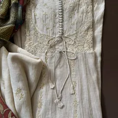 A close-up of the Anarkali's bodice, showcasing the intricate Chikankari, button details, and adjustable ties. The coordinated tissue chanderi dupatta is visible in the background.