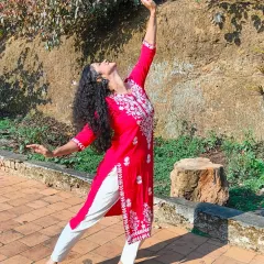 Another pose from my dance session in Coorg, reaching upwards with a graceful hand gesture. This shows the expressive potential of semi-classical dance, which I love to explore in my choreography.
