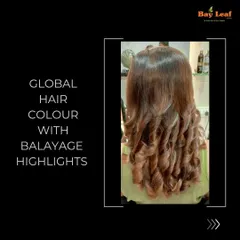 Another look at a global color combined with balayage highlights. The result is these perfectly formed, glossy curls where you can see the seamless blend of the base color and the lighter, hand-painted pieces.