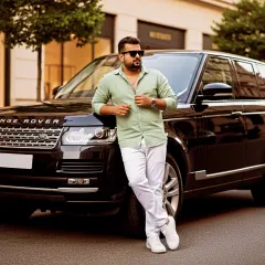 Leaning against a Range Rover, this photo captures a moment of urban luxury. It reflects the premium, high-quality sound I strive for in my music production services.