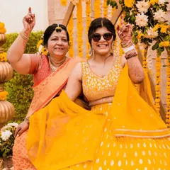A beautiful moment of shared joy between the bride and her mother during the Haldi ceremony. We focus on capturing the emotional connections between family members during these important rituals.