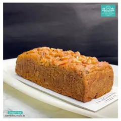 A full view of our whole wheat Dates & Walnut loaf cake. It's a hearty, wholesome cake packed with natural sweetness from dates and the crunch of walnuts.