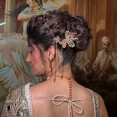 A detailed close-up of the textured bun and the beautiful butterfly hairpiece. I love adding unique accessories to make a hairstyle truly special.