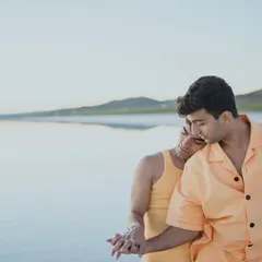 A tender and quiet moment between a couple on a Turkish beach. One partner rests their head on the other's shoulder, conveying a sense of comfort, trust, and deep affection.