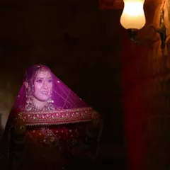 A moody and atmospheric bridal portrait. Using the warm glow of a single lamp, I created this intimate shot that highlights the bride's delicate features and her veil.