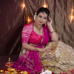 A full-length shot from the festive Diwali photoshoot. The makeup is designed to complement the vibrant pink and gold lehenga, creating a complete, celebratory look.
