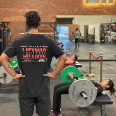 "Just Keep Lifting Fullpower." A coach watches over a member performing hip thrusts, ensuring proper technique for maximum results and safety.