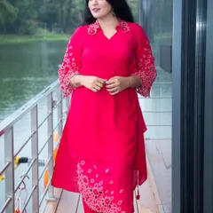 This shot features a model in a vibrant pink kurta set, captured in motion on a wooden deck. The focus is on showing how the garment moves and looks in a real-world setting.