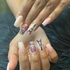 A close-up of our hand-painted "Parisian Love" design. This set features detailed illustrations of the Eiffel Tower and perfume bottles on long, square-shaped extensions.