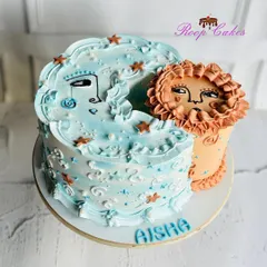A whimsical sun and moon cake for Aisha. This unique design features two interconnected cakes representing day and night, decorated with dreamy, artistic faces and starry details.
