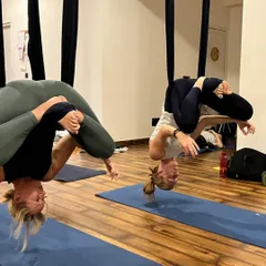 One of the most exciting parts of our curriculum is Aerial Yoga. In this shot, my teacher training students are practicing an inverted Baddha Konasana (Bound Angle Pose) in the silks. This not only builds incredible core strength but also helps decompress the spine and see the world from a new perspective.