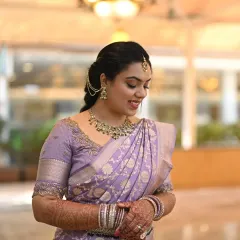 The epitome of South Indian elegance. This bride is wearing a stunning lavender Kanjeevaram silk saree for her engagement. I created a soft, glowing makeup look and a traditional braided hairstyle to complement her timeless attire.