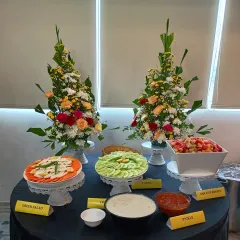 We believe in fresh and beautiful presentations, even for the simplest items. This is our salad and pickle station at a corporate lunch, featuring a variety of fresh-cut salads, raita, and pickles, elegantly displayed to complement the main course.