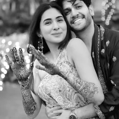 A playful and happy black and white moment. Rupanshi showing off her mehndi design adds a lovely detail to this candid portrait with Yash.