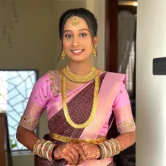 Dolled up my gorgeous bride for her pre-wedding rituals. This look features a beautiful pink and brown saree, complemented by simple gold jewelry and a soft, natural makeup look.