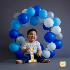 That joyful, gummy smile says it all. We create beautiful balloon wreaths and provide light-up marquee numbers to make your baby's first birthday photos extra special.