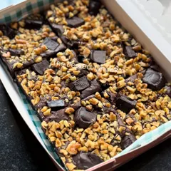 A box full of my irresistible Walnut Brownies. They are loaded with crunchy walnuts and chocolate chunks for the perfect balance of textures.