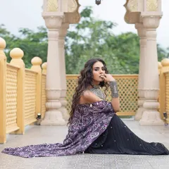 A seated pose from the Sajeda Lehry shoot, showcasing the beautiful drape of the outfit and the intricate silver jewellery.