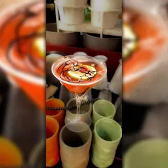 A beautifully presented cocktail in a martini glass, garnished with a slice of fruit and a chocolate drizzle. I focus on presentation to make every drink an experience.