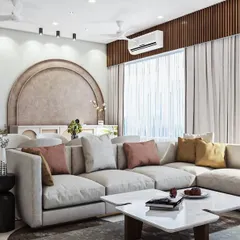 For larger, open-plan homes, I focus on creating distinct zones that still feel connected. This spacious living area features a plush, oversized L-shaped sofa for ultimate comfort, while an elegant arched feature wall in the background defines the dining space with a touch of architectural grace.