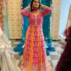 Feel pretty like the moon in this stunning pink and orange Anarkali style gown. The heavy embroidery on the yoke makes it a rich and festive outfit, perfect for a wedding or reception.