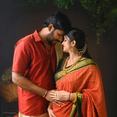 An intimate and heartfelt pose during a South Indian traditional maternity shoot. The rich colors of the saree and the traditional jewelry add to the beauty of the moment.