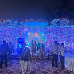 The same floral wall from the daytime setup, now completely transformed by night. I used dramatic blue uplighting to give the flowers a magical, otherworldly glow for the evening reception.