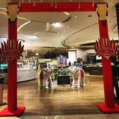 The entrance to a Sri Lankan Food Festival, which I designed with a traditional red gate, symbolic Gini Raksha masks, and decorated elephant statues.