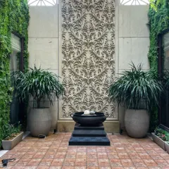 A stunning courtyard we designed, featuring two large Dracaenas in polymer pots flanking a beautiful water feature. This kind of symmetrical design creates a sense of calm and luxury.