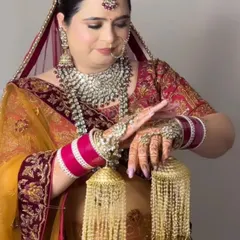 A beautiful bride in a unique yellow and maroon lehenga. The makeup is kept soft and glowing to complement the heavy silver jewellery.