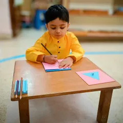 Look at the concentration. This child is working with geometric insets, an activity that indirectly prepares the hand for writing by strengthening the pincer grip and developing hand-eye coordination. This is how we build foundational skills naturally.