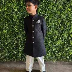 Main character energy in our classic black sherwani. This piece is all about sharp, tailored lines and a confident look, perfect for the little gentleman who loves to stand out at family weddings and receptions.