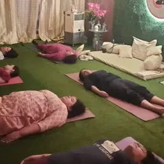 Participants in a state of deep rest during Yog Nidra. This guided practice brings you to a state between waking and sleeping, where your body and mind can completely rejuvenate.