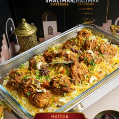 Our Mutton Dum Biryani, garnished with cashews and fragrant spices, is a centerpiece of our festive offerings, perfect for any large celebration.