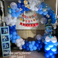 A decoration for an Annaprashan (first rice-eating ceremony). This setup features a blue and white balloon ring, 'BABY' blocks, and a custom banner.