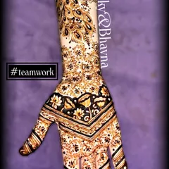 A stunning back hand design created by our team. The chevron pattern on the hand flows into a beautiful peacock feather design up the arm.