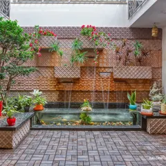 This home features a central rain court with a water body and a cascading water-wall made of carved stone. It acts as the home's microclimate, cooling the air and creating a tranquil soundscape.