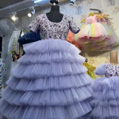 Here is a look at a mother-daughter twinning set on mannequins. The lavender gowns feature intricate hand embroidery on the bodice and a full, tiered tulle skirt.