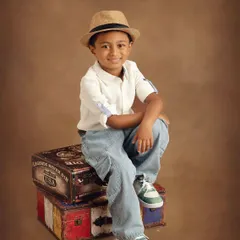 This is one of my favorite shots from the session. The vintage trunks and stylish fedora create a fun "little explorer" theme, perfect for a kids' clothing brand lookbook.