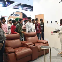 Here, I am demonstrating the capabilities of our home theater setups to visitors at an exhibition. You can see the sleek, wall-mounted keypads that provide simple control over the entire experience.