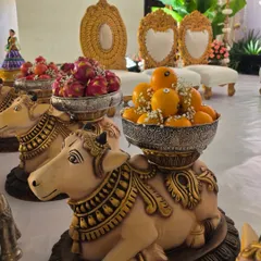 A close-up of my popular cow statues used as decorative stands for holding bowls of fruit offerings.